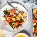 One pan chicken sausage with potatoes, broccoli, zucchini, and bell peppers on a plate.