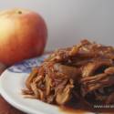 Slow cooker barbecue turkey breast with apples, onions, and barbecue sauce on a plate. 