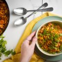 Turkey taco skillet with beans, corn, ground turkey, and rice in a bowl with cilantro and green onions.
