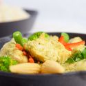 Slow Cooker Thai Curry Chicken with vegetables and curry sauce in a bowl with rice.