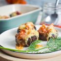 Mexican stuffed mushrooms with ground turkey, veggies, and enchilada sauce.