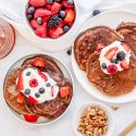 Almond flour pancakes with flax served with fresh berries, yogurt, nuts, and honey.