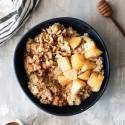 Apple cinnamon quinoa breakfast bowl with chopped apples, cinnamon, cooked, quinoa, and walnuts. 