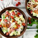 BLT Pasta salad with lettuce, tomatoes, bacon, and spaghetti in a bowl with ranch dressing.