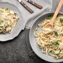 Chicken and broccoli pasta in a bowl with a creamy Parmesan sauce.