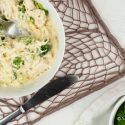 Creamy Parmesan Spaghetti Squash with chicken breast and broccoli in a bowl.