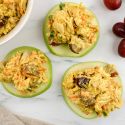 Curried chicken salad with grapes on apple slices.