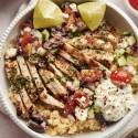 Greek chicken bowls with grilled chicken, tomatoes, cucumbers, red onions, feta cheese, red onions, and quinoa. 