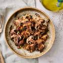 Grilled mushrooms with balsamic vinegar, olive oil, and garlic powder on a plate.