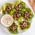 Asian ground beef lettuce wraps with bell peppers, peanuts, and green onions.