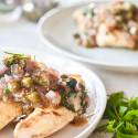 Healthy chicken piccata on a plate with a garlic, butter, and caper sauce.