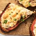 Healthy tuna melt served open faced with tomato slices and cheddar cheese.