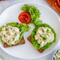 Healthy egg salad with fresh herbs, Greek yogurt, and hard boiled eggs on whole wheat bread.