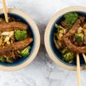 Hoisin pork stir fry with cabbage, broccoli, and carrots in a wooden bowl.
