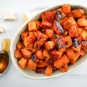Roasted sweet potatoes with garlic cloves and a spoonful of honey.