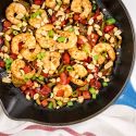 Kung Pao Shrimp with peanuts, celery, red peppers, and green onions in a skillet.