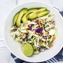 Mexican coleslaw with lime Greek yogurt dressing with cabbage, carrots, cilantro, and avocado.