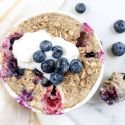 Microwave blueberry muffin in a ramekin with blueberries, yogurt, and walnuts.