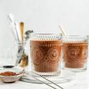 Mocha coffee smoothie with bananas, instant coffee, almond milk, and cocoa powder blended in two glasses.