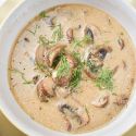 Mushroom soup with fresh cooked mushrooms, garlic, onion, and thyme in a healthy creamy broth.