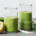 Pineapple cucumber smoothie with bananas, spinach, cucumber, and pineapple blended and served in two glasses.