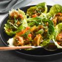 Vegetarian lettuce wraps with quinoa, mushrooms, red peppers, hoisin sauce, and butter lettuce. 