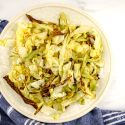 Roasted cabbage in pieces with browned edges on a plate.