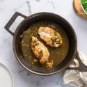 Rosemary chicken with garlic butter in a skillet with pan sauce.