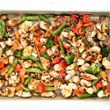 Thai Cashew Chicken with vegetables on a sheet pan.