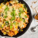 Mexican brown rice casserole with black beans, corn, tomatoes, bell peppers, and spices.