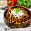 Slow cooker lentil sloppy joes with cheese in a wooden bowl.