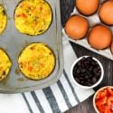 Black bean egg muffins in a muffin tin with eggs, black beans, and red pepper on the side. 
