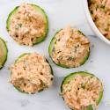 Spicy tuna salad on cucumber slices with sesame seeds.