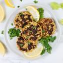 Tuna patties with crispy edges on a plate with fresh lemon and parsley.