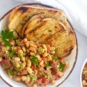 Stewed basil white beans with tomatoes, onions, garlic, and pesto sauce with garlic bread.