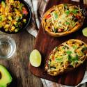 Stuffed sweet potatoes with Southwest ingredients including black beans, corn, diced tomatoes, green peppers, and cheese.