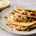 Tacos gobernador with shrimp, melted cheese, poblano peppers, onions, and cilantro in grilled corn tortillas.