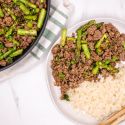 Thai Basil Ground Beef on a plate with rice and a skillet.