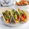 Tofu fajitas with extra firm tofu, red bell peppers, green bell peppers, and red onions cooked in spices served in flour tortillas with guacamole.