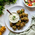Turkish kofte meatballs made with ground lamb, beef, herbs, and spices served with yogurt sauce and salad.