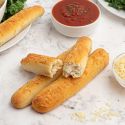 Two ingredient dough breadsticks made with Greek yogurt and self rising flour on a plate with marinara sauce on the side.