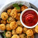 Vegetarian chickpea nuggets in a baking dish with fresh parsley and ketchup.