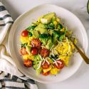Veggie scramble with broccoli, tomatoes, onions, red pepper, and topped with avocado.