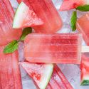 Watermelon popsicles with fresh watermelon and honey with ice cubes and fresh watermelon slices.