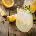 White wine spritzer in a glass with lemon and rosemary. 