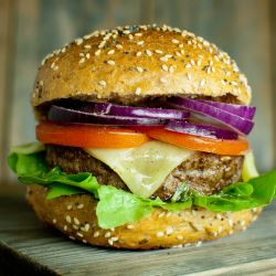 Ranch burgers made with ground beef and topped with cheese, lettuce, tomato, and onion. 