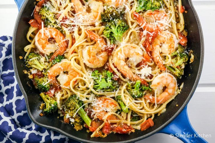 Shrimp and broccol pasta with lemon and garlic in a skillet.