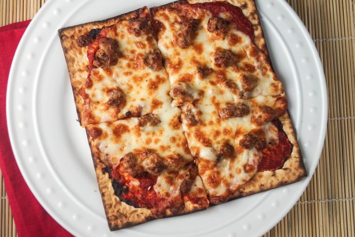 Matzo pizza with melted cheese and tomato sauce. 