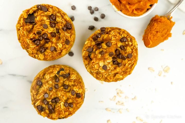 Baked pumpkin oatmeal with chocolate chips and a spoon of pumpkin.