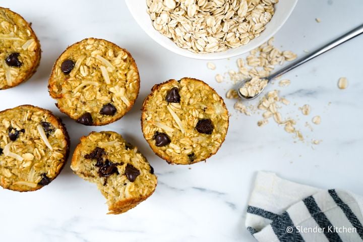 Banana oatmeal muffins with chocolate chips on a marble board.